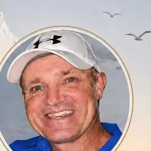 Jeremy Wood smiling in a blue shirt and baseball cap